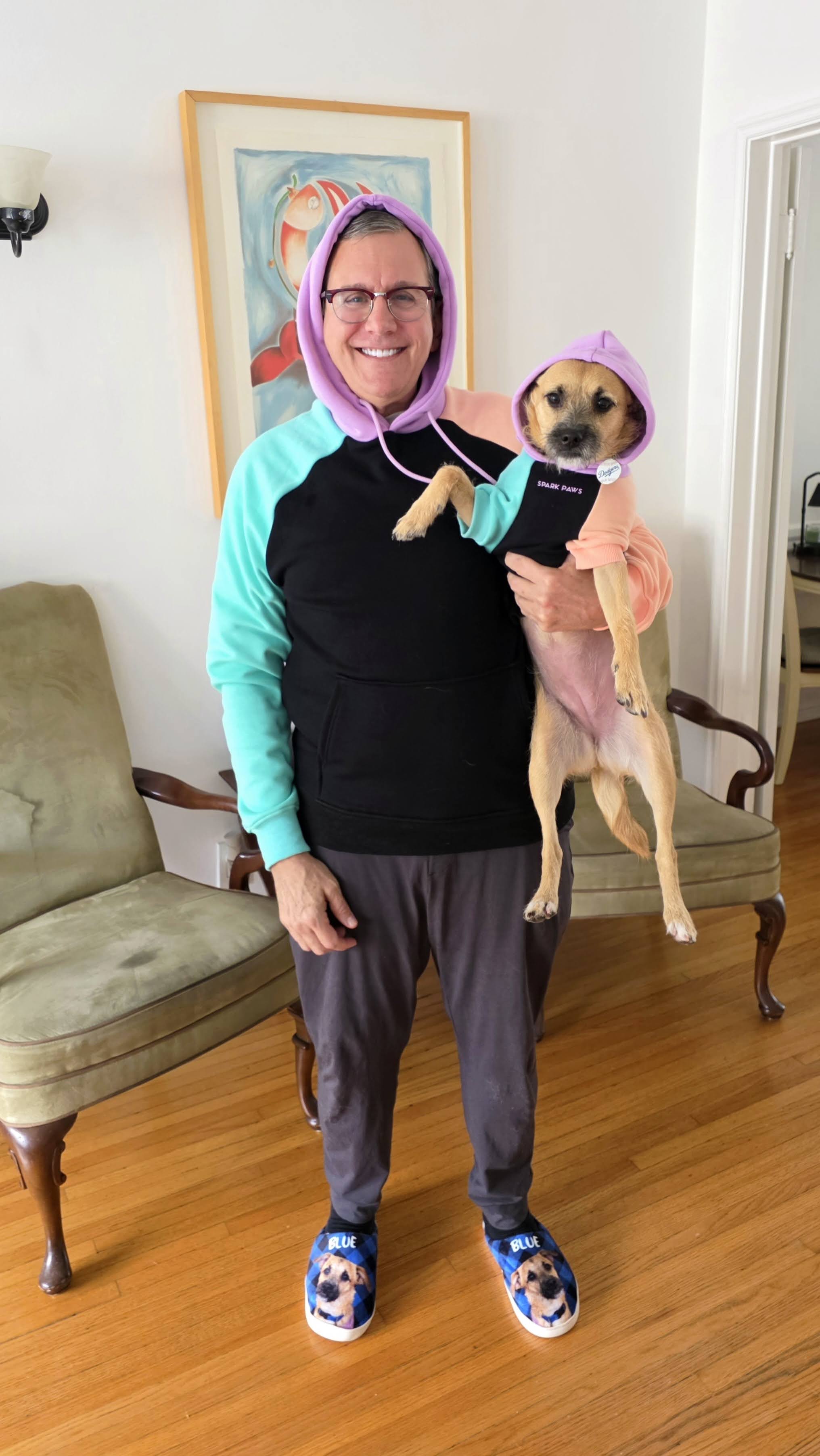 Carey holding a small dog at home